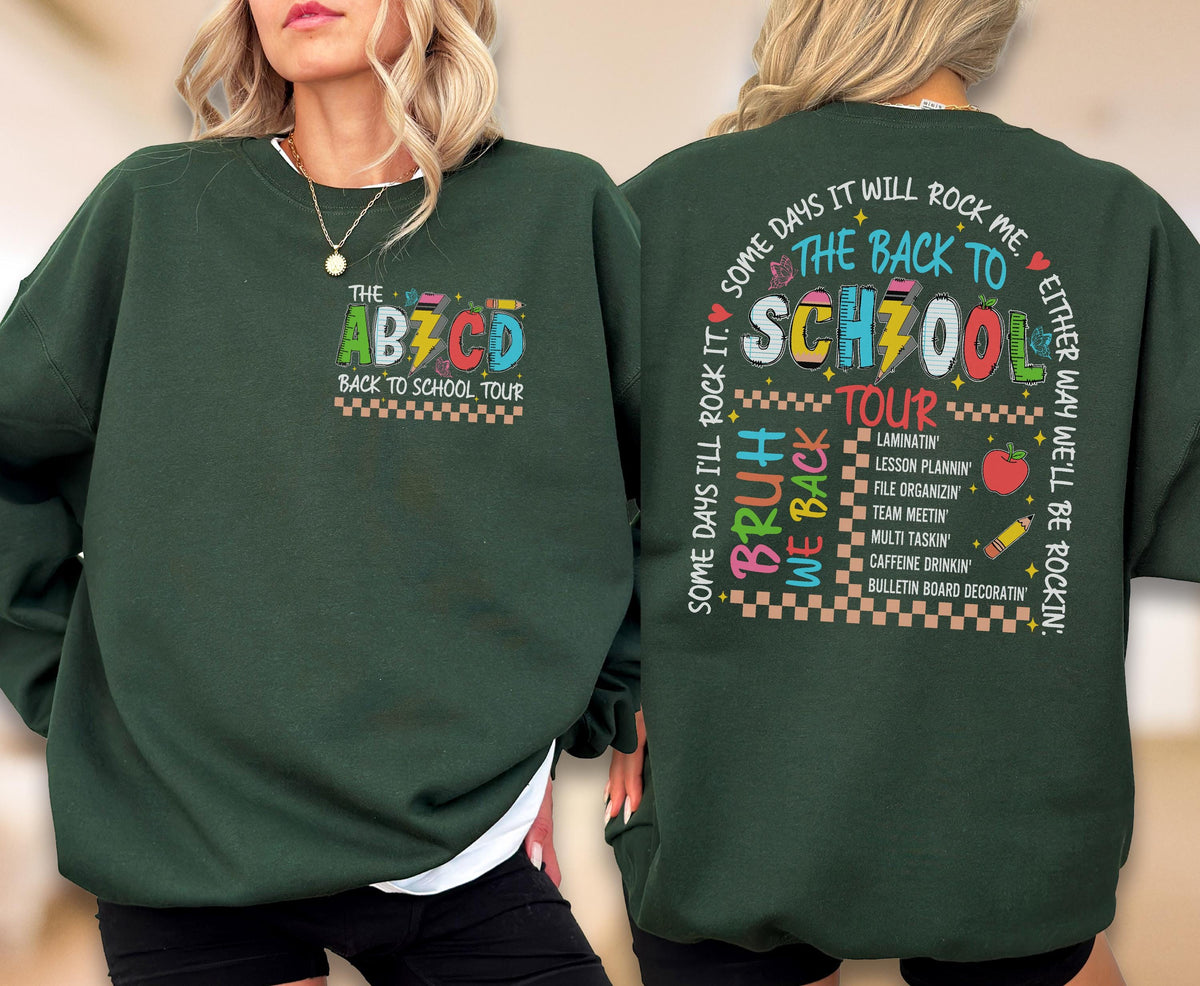 May include: Dark green sweatshirt with the text "THE AB7CD BACK TO SCHOOL TOUR" on the front. The back of the sweatshirt says "SOME DAYS IT WILL ROCK ME THE BACK TO SCHZOO TOUR" with a list of school-related activities.