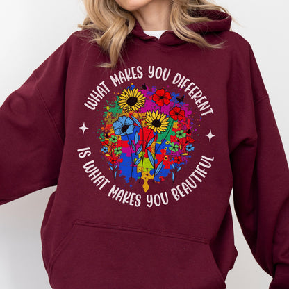 May include: Burgundy hoodie with a colorful floral design. The design includes sunflowers, red flowers, and blue flowers. The text on the hoodie reads "WHAT MAKES YOU DIFFERENT IS WHAT MAKES YOU BEAUTIFUL."
