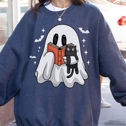 May include: A navy blue sweatshirt featuring a cartoon ghost reading a book with a black cat. The ghost is holding an orange book, and the cat is hugging the book. White bats and stars are scattered around the ghost.