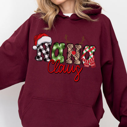 May include: Burgundy hoodie with a festive "Nana Claus" design. The text features a Santa hat, reindeer antlers, and plaid patterns in black and white, green, and red. The word "Claus" is in red script.