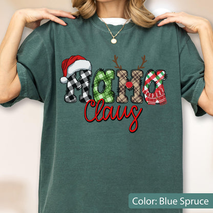 May include: A blue spruce t-shirt featuring the text "MAMA Claus" in a decorative font. The letters are filled with various plaid patterns, including black and white, green, and brown. A red Santa hat and reindeer antlers are on the letters.