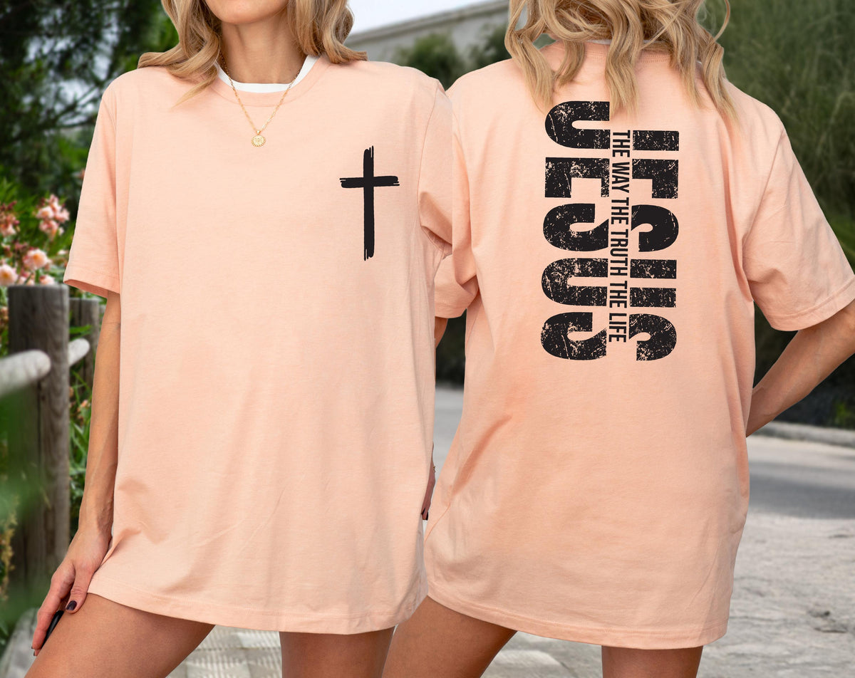 May include: Peach-colored t-shirt with a black cross on the front and the text "JESUS THE WAY THE TRUTH THE LIFE" on the back. The shirt is a casual, short-sleeved style.