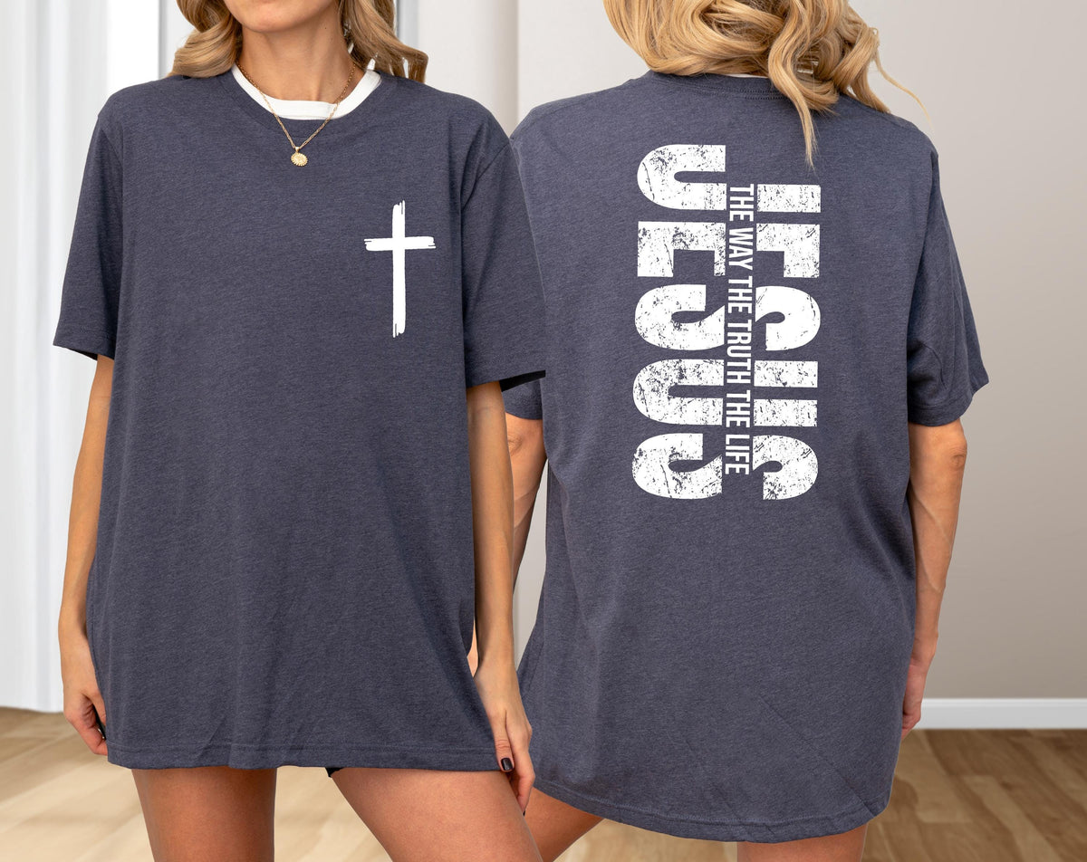 May include: Dark gray t-shirt with a white cross on the front and the word "JESUS" vertically on the back, along with the text "THE WAY THE TRUTH THE LIFE". The shirt has a crew neck and short sleeves.