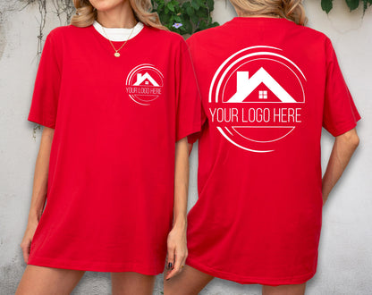May include: Red t-shirt with white trim and a white logo on the front and back. The logo features a house silhouette inside a circle with the text "YOUR LOGO HERE". The shirt is a casual, oversized fit.