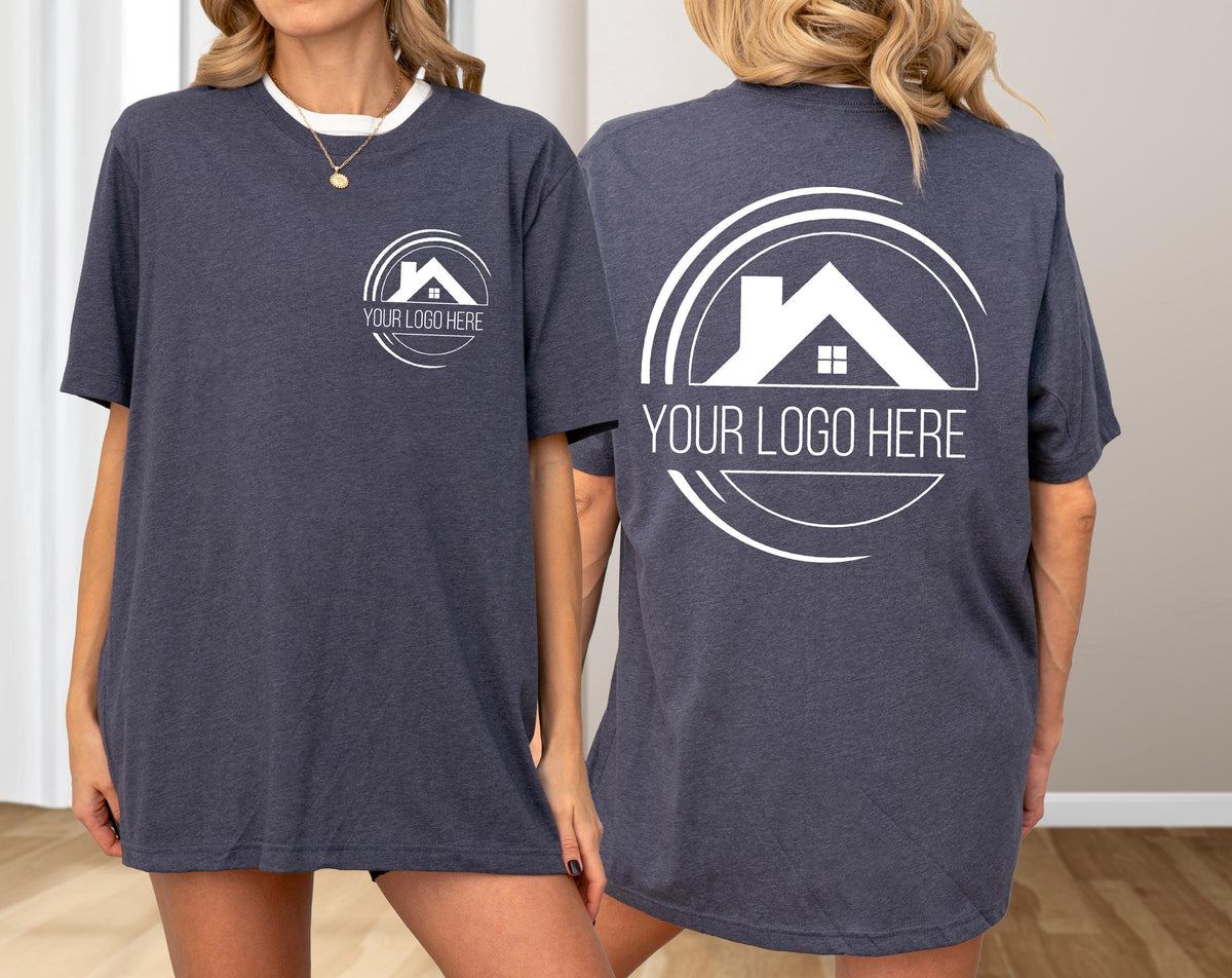 May include: Dark gray t-shirt with a white collar and a white logo on the front and back. The logo features a house icon and the text "YOUR LOGO HERE". The shirt is short-sleeved.