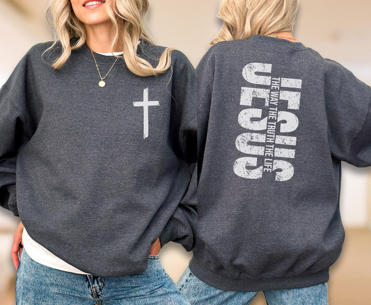 May include: A dark gray sweatshirt with a white cross on the front and the words "JESUS THE WAY THE TRUTH THE LIFE" printed vertically on the back. The sweatshirt is a casual, comfortable style.