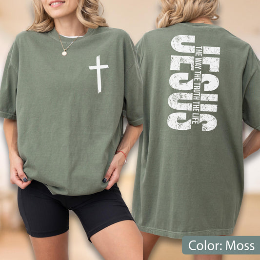 May include: Moss green t-shirt with a white cross on the front and the word "JESUS" and the phrase "THE WAY THE TRUTH THE LIFE" printed on the back. The shirt is a relaxed fit.