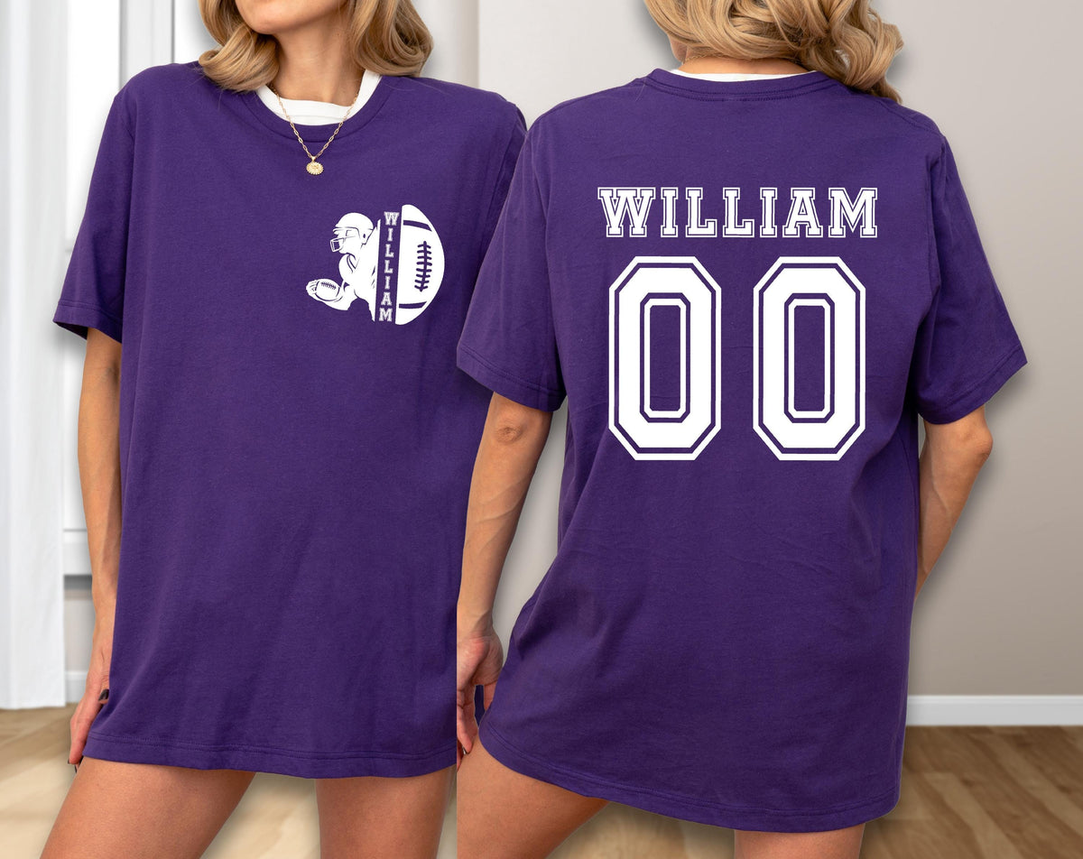May include: A purple t-shirt with a white collar. The front features a white graphic of a football player and a football, with the name "WILLIAM" printed vertically. The back displays "WILLIAM" above the number "00" in a white, outlined font.