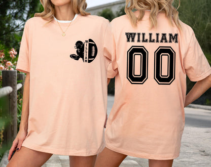May include: Peach-colored t-shirt with a black football graphic and the name "WILLIAM" on the front and back. The back of the shirt also features the number "00" in a black, outlined font. The shirt is a casual, unisex style.