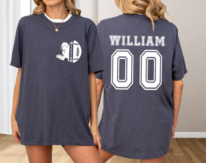 May include: Dark gray t-shirt with a white collar. The front features a football graphic with the name "WILLIAM" and a football. The back displays "WILLIAM" above the number "00" in white.