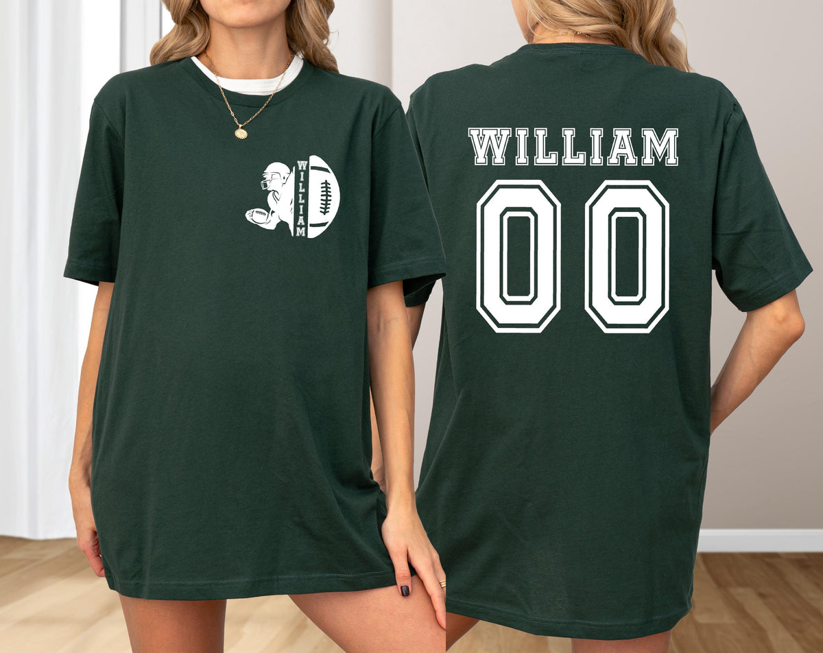 May include: Dark green t-shirt with white graphics. The front features a football player and football with the name "WILLIAM". The back displays "WILLIAM" above the number "00". A casual, unisex tee.