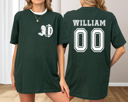 May include: Dark green t-shirt with white graphics. The front features a football player and football with the name "WILLIAM". The back displays "WILLIAM" above the number "00". A casual, unisex tee.