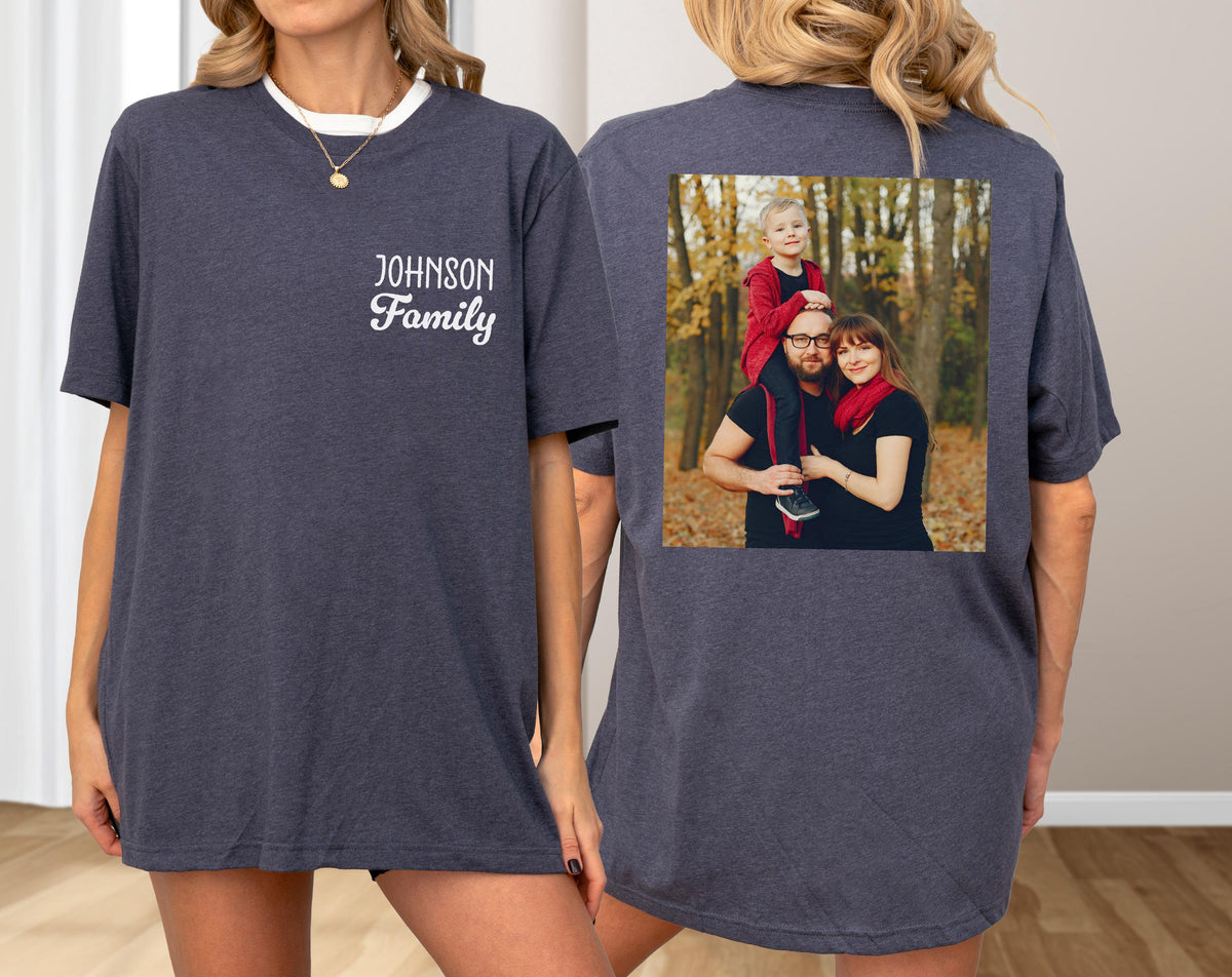 May include: Dark gray t-shirt with a white collar and the text "JOHNSON Family" on the front. The back of the shirt features a family photo. The shirt is a casual, comfortable style.