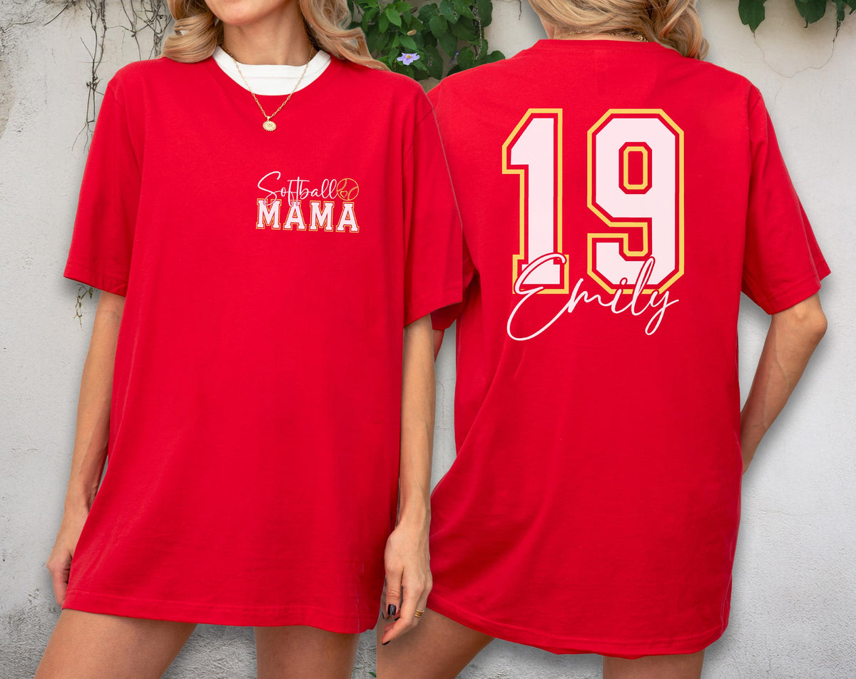 May include: Red t-shirt with white collar featuring "Softball Mama" text on the front and the number 19 with the name "Emily" on the back. The shirt has a relaxed fit and short sleeves.