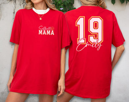 May include: Red t-shirt with white collar featuring "Softball Mama" text on the front and the number 19 with the name "Emily" on the back. The shirt has a relaxed fit and short sleeves.