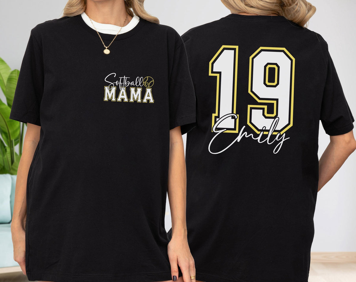 May include: Black t-shirt with a white crew neck. The front features "Softball MAMA" in a gold and white design. The back displays the number "19" in white with a gold outline, and the name "Emily" in a script font.