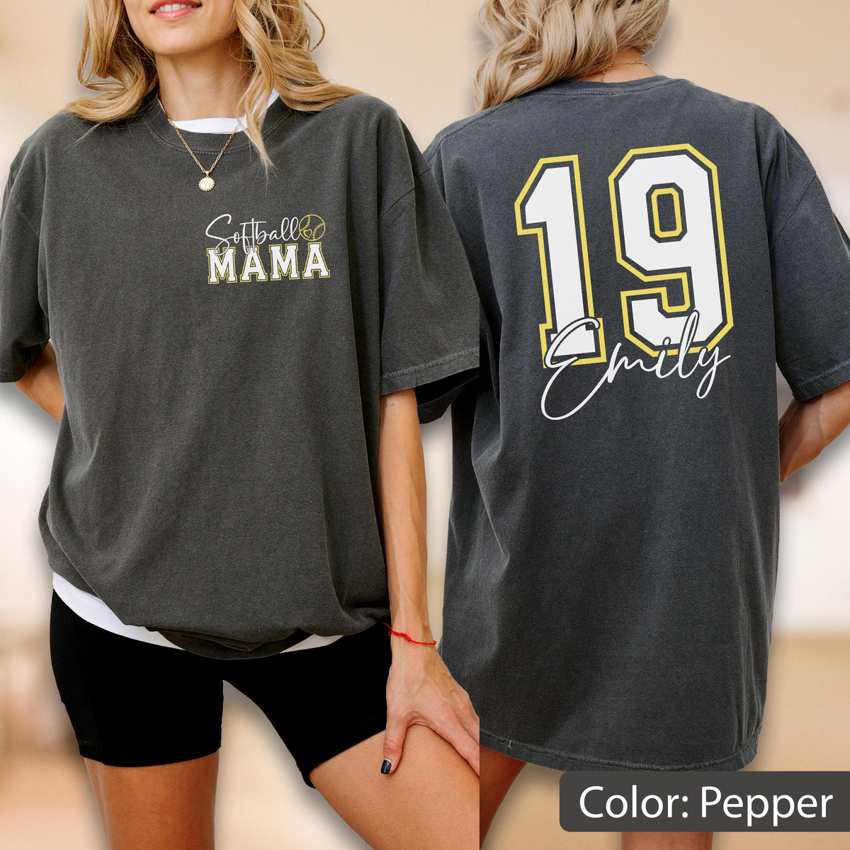 May include: Pepper-colored t-shirt with "Softball Mama" text on the front and the number 19 with a name on the back. The front design includes a softball graphic. The shirt is a relaxed fit, with short sleeves.