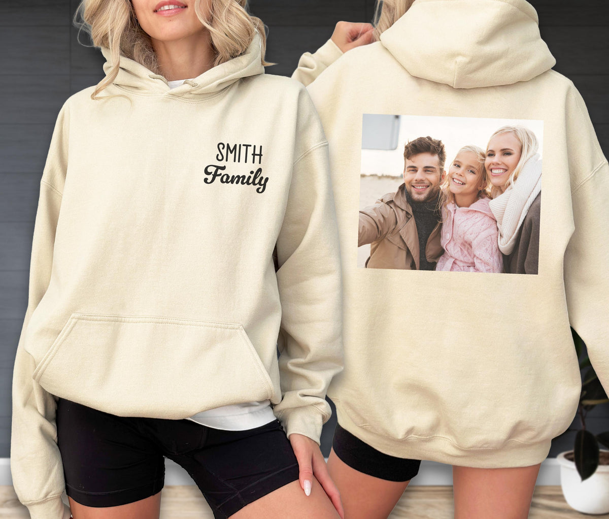 May include: Cream-colored hoodie with a front pocket and a hood. The front of the hoodie has the text "SMITH Family" in black script. The back of the hoodie features a printed photograph of a family.