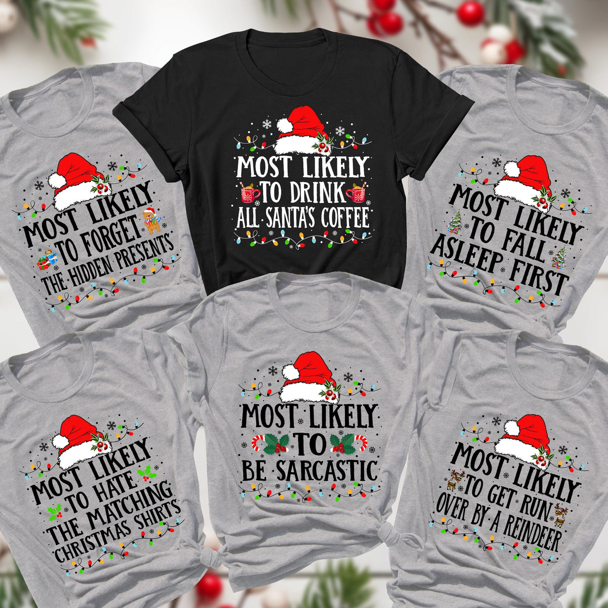 May include: A collection of Christmas-themed t-shirts in various colors, including gray and black. Each shirt features a Santa hat and text like "Most Likely to Drink All Santa's Coffee" and "Most Likely to Forget the Hidden Presents."