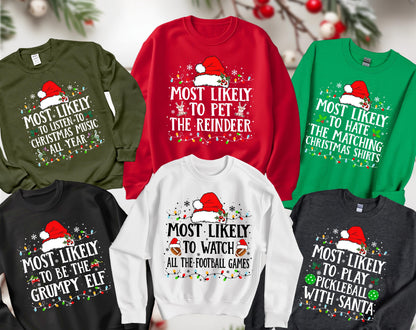 May include: A collection of five crewneck sweatshirts in olive green, red, bright green, black, and white. Each features a Santa hat graphic, colorful Christmas light strings, and text including Most Likely To Listen To Christmas Music, Pet The Reindeer, Hate The Matching Christmas Shirts, Be The Grumpy Elf, Watch All The Football Games, and Play Pickleball With Santa.