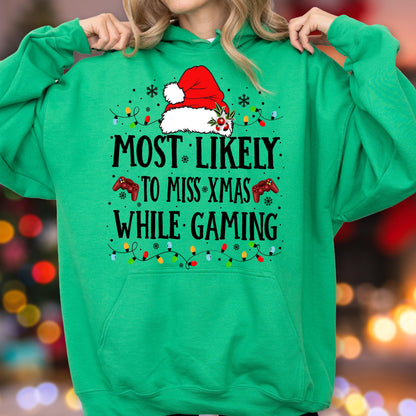 May include: A bright green hooded sweatshirt featuring a graphic print of a red Santa hat, two red game controllers, and colorful Christmas light strings. The text reads: MOST LIKELY TO MISS XMAS WHILE GAMING, accented with small black snowflakes.