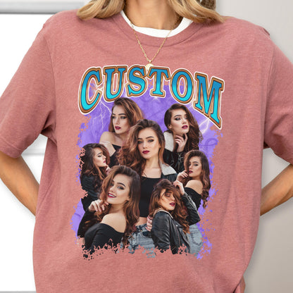 May include: A mauve-colored t-shirt featuring a graphic design with the word "CUSTOM" in a retro font. The design includes a collage of women with long brown hair, set against a purple background with lightning bolts.
