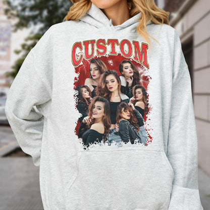 May include: A light gray hoodie featuring a graphic of multiple women with long brown hair. The graphic has a red background with the word "CUSTOM" in a red and gold font.