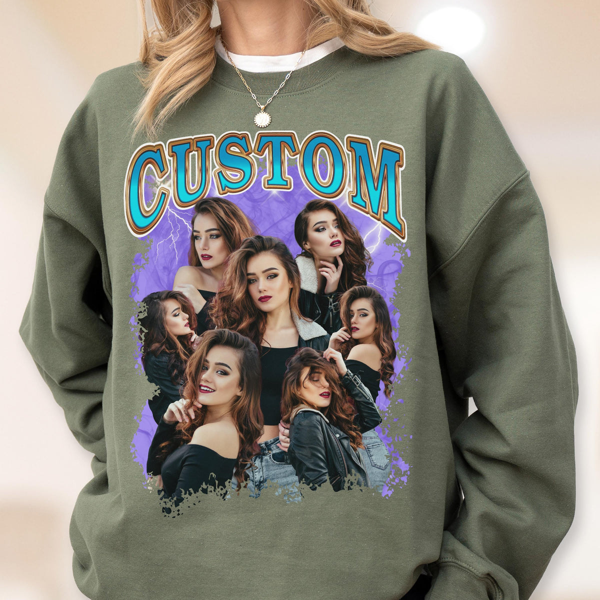 May include: An olive green sweatshirt featuring a graphic design with the word "CUSTOM" in a blue and gold font. The graphic includes a collage of women's portraits against a purple background with lightning bolts.