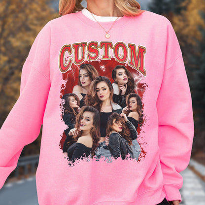 May include: Pink sweatshirt with a graphic featuring multiple women and the word "CUSTOM" in red and gold lettering. The graphic has a red background with lightning bolt designs.