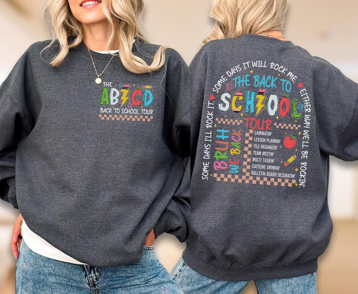 May include: A dark gray sweatshirt with the text "THE ABZ CD BACK TO SCHOOL TOUR" on the front. The back of the sweatshirt has the text "SOME DAYS I'LL ROCK IT. SOME DAYS IT WILL ROCK ME. BRUH WE BACK THE BACK TO SCH700L TOUR".