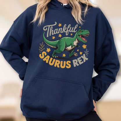 May include: Navy blue hoodie with a green dinosaur graphic and the text "Thankful Saurus Rex" in a circular design. The dinosaur is surrounded by yellow leaves and a sprig of leaves.