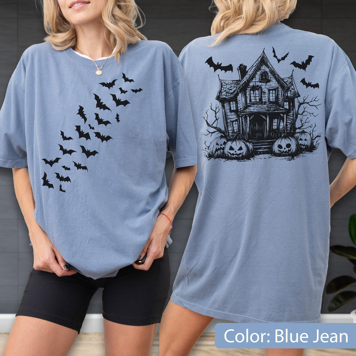 May include: A blue jean colored t-shirt featuring a black graphic print. The front displays a swarm of flying bats. The back features a detailed illustration of a haunted house surrounded by bare trees, jack-o'-lantern pumpkins, and flying bats.