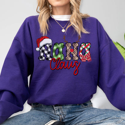 May include: A purple sweatshirt with the text "Nana Claus" in a festive design. The word "Nana" features a Santa hat and plaid patterns, while "Claus" is in red script, creating a holiday theme.