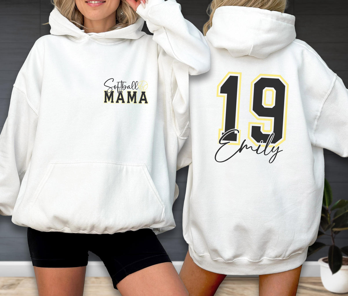 May include: White hooded sweatshirt with a front pocket and drawstring. The front features the text "Softball MAMA" in black and gold. The back displays the number "19" in black and gold, with the name "Emily" below.