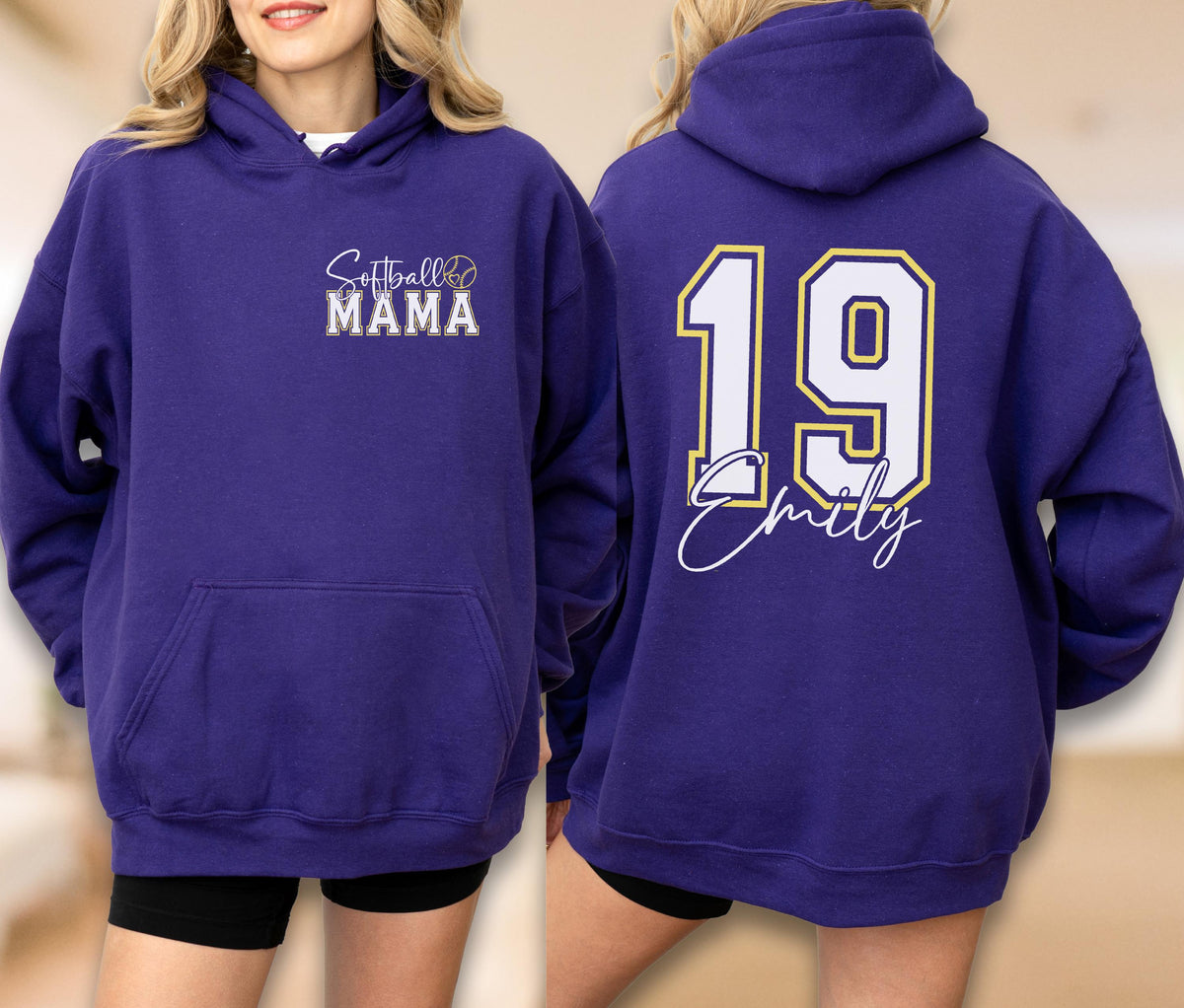 May include: A purple hoodie with the text "Softball Mama" on the front and the number "19" with a name on the back. The hoodie has a front pocket and a hood. The text and numbers are in white and gold.