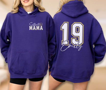May include: A purple hoodie with the text "Softball Mama" on the front and the number "19" with a name on the back. The hoodie has a front pocket and a hood. The text and numbers are in white and gold.