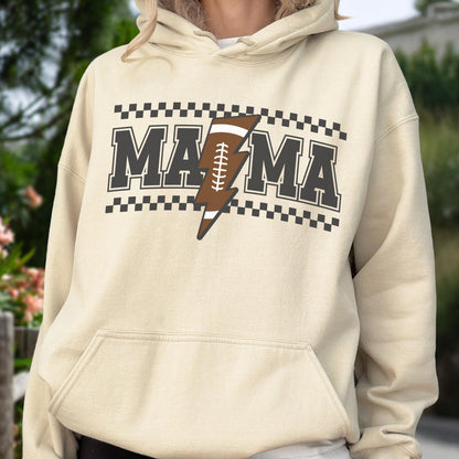 May include: A beige hoodie with a front graphic that says "MAMA" in dark gray block letters, with a brown football-shaped lightning bolt in the center. The design is framed by a black and white checkered pattern.