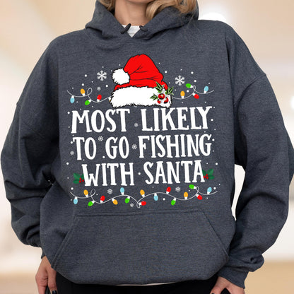 May include: A dark charcoal gray hooded sweatshirt featuring a graphic print of a red Santa hat with holly, white snowflakes, and colorful Christmas lights. The text reads, "MOST LIKELY TO GO FISHING WITH SANTA" in bold white capital letters.