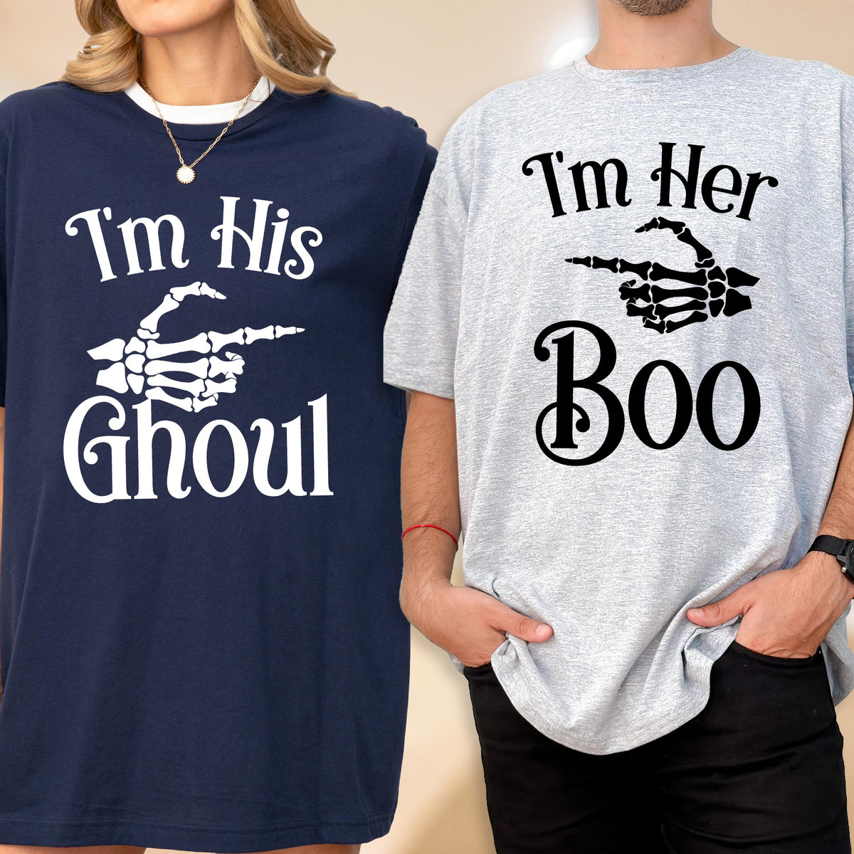 May include: A navy blue t-shirt with white text reading I'm His Ghoul and a skeleton hand graphic, alongside a light gray t-shirt with black text reading I'm Her Boo and a skeleton hand graphic pointing toward the navy blue t-shirt.