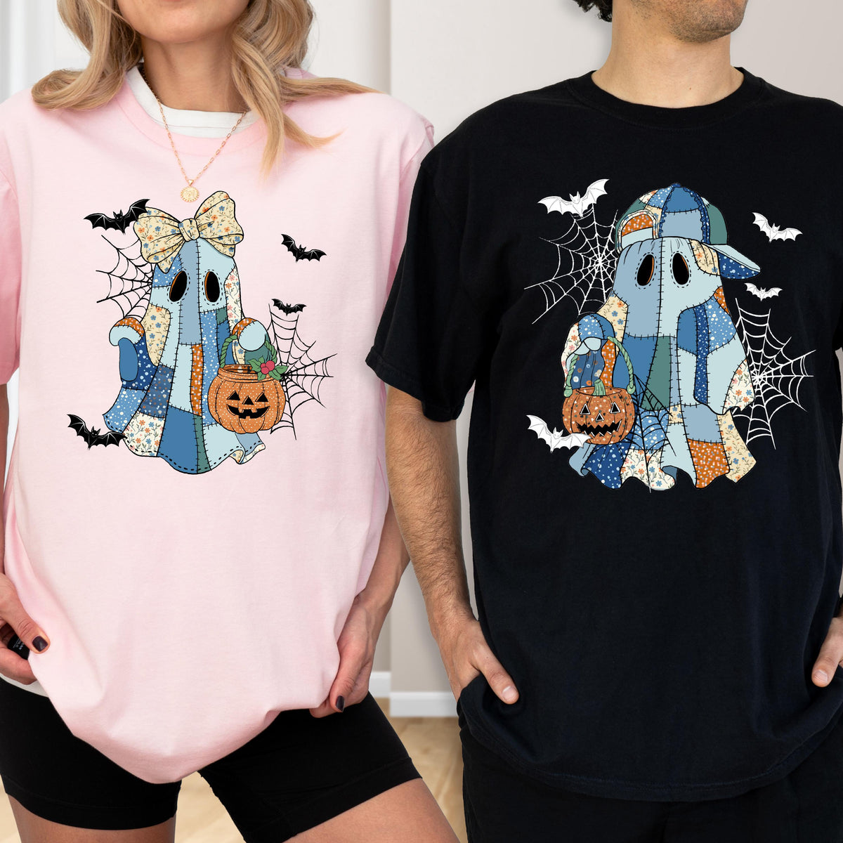 May include: Pink and black t-shirts featuring a patchwork ghost design with a pumpkin basket, spiderwebs, and bats. The ghost wears a bow. The black shirt has a ghost wearing a cap. Halloween-themed apparel.