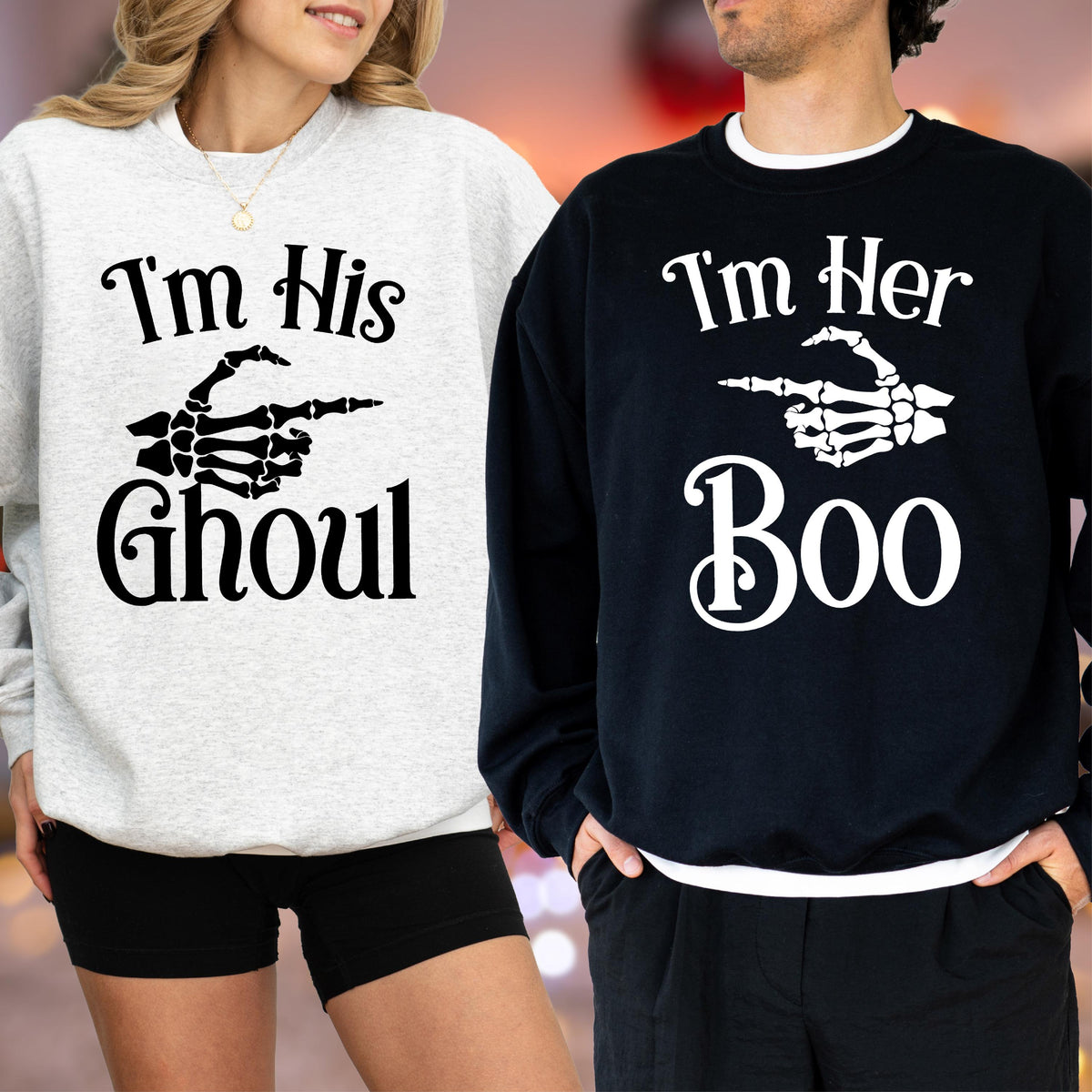 May include: Two matching Halloween sweatshirts. One is light gray with the text "I'm His Ghoul" and a skeleton hand pointing to the right. The other is black with "I'm Her Boo" and a skeleton hand pointing to the right.