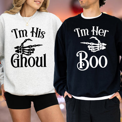 May include: Two matching Halloween sweatshirts. One is light gray with the text "I'm His Ghoul" and a skeleton hand pointing to the right. The other is black with "I'm Her Boo" and a skeleton hand pointing to the right.
