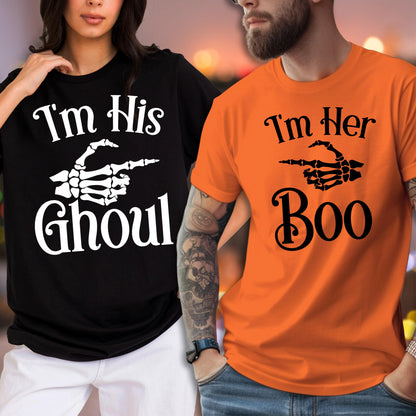 May include: A black t-shirt with white text reading I'm His GHOUL and a white skeleton hand graphic, alongside an orange t-shirt with black text reading I'm Her Boo and a black skeleton hand graphic pointing to the side on both shirts.