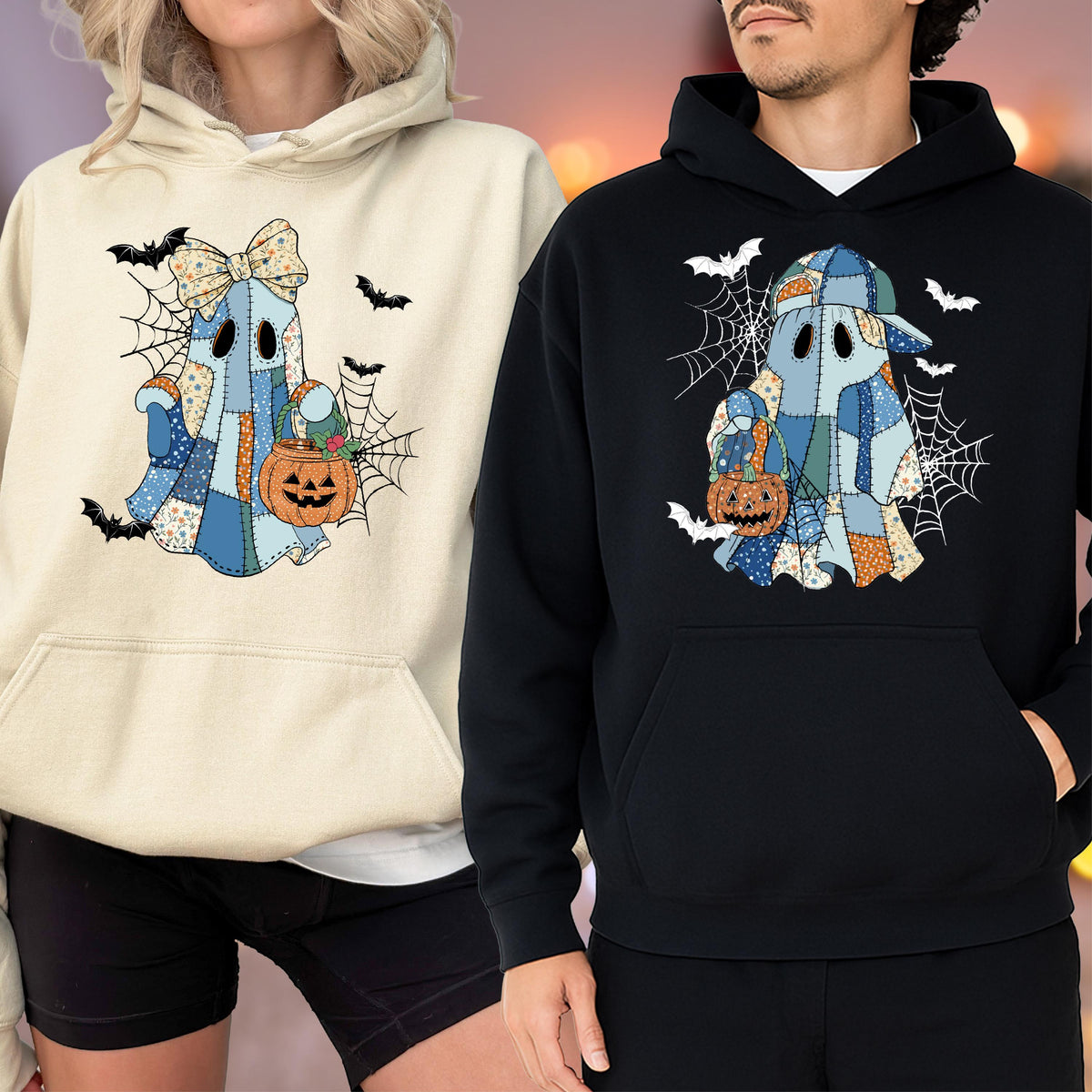 May include: A cream-colored hoodie and a black hoodie, each featuring a graphic of a ghost made of blue and orange patchwork fabric. The ghosts are surrounded by spiderwebs and bats, and each holds an orange jack-o'-lantern candy bucket.