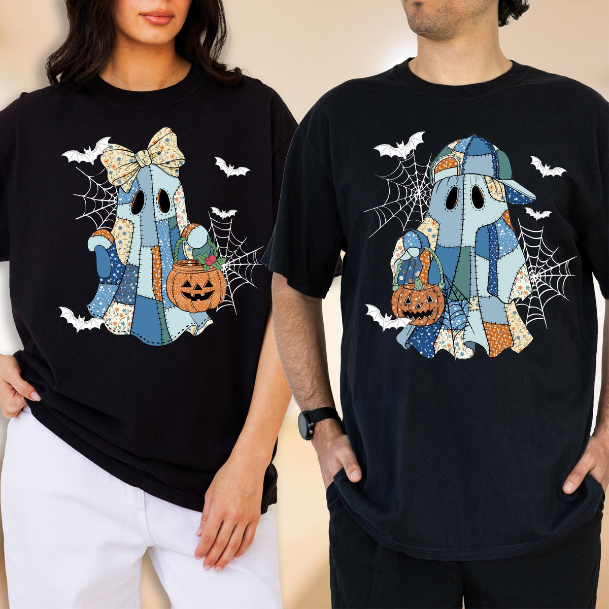 May include: Two black t-shirts featuring a patchwork ghost graphic. The left ghost wears a bow, the right ghost wears a baseball cap. Both ghosts hold orange jack-o'-lantern buckets against a background of white spiderwebs and flying bats.