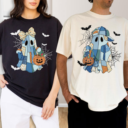 May include: A black t-shirt and a cream t-shirt, each featuring a graphic of a ghost made of blue and orange patchwork fabric. The ghosts hold orange jack-o'-lantern buckets, surrounded by black spiderwebs and small flying bats.