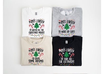 May include: Four Christmas-themed sweatshirts in white, gray, tan, and black. Each shirt has a festive design with the text "MOST LIKELY" above a Christmas tree and candy canes, with different phrases below, such as "to watch all the Christmas movies."