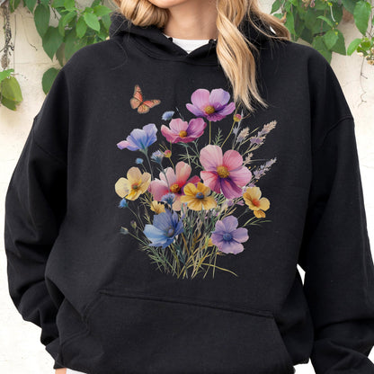 May include: Black hooded sweatshirt featuring a watercolor floral design with pink, purple, yellow, and blue flowers. A small orange butterfly is also present. The sweatshirt has a front pocket.