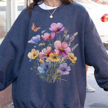 May include: A navy blue sweatshirt featuring a vibrant floral design with pink, yellow, and purple flowers. A butterfly is also present. The sweatshirt is a comfortable, casual style.