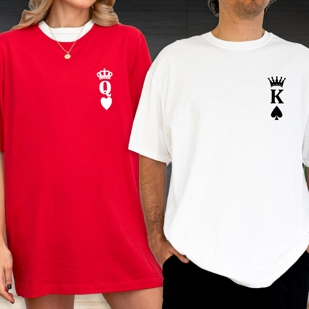 May include: Red and white t-shirts. The red shirt has a white Queen of Hearts design. The white shirt has a black King of Spades design. Both shirts are short-sleeved and have a crew neck.